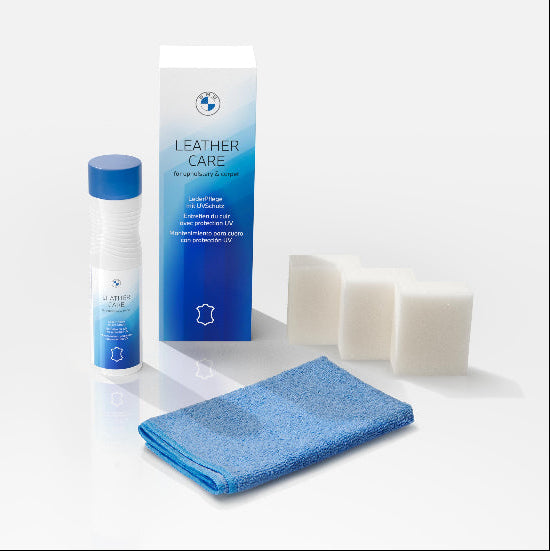 BMW leather care product set with bottle, box, towel, and cloths on a white background